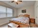 Well-lit bedroom with a cozy aesthetic featuring a bed with wood frame at 4191 Secret Shoals Way, Buford, GA 30518