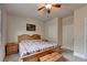 Bright bedroom featuring natural wood furniture, a cozy quilt, and lots of natural light at 4191 Secret Shoals Way, Buford, GA 30518