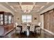 Traditional dining room boasts coffered ceiling, dark wood floors, and a custom sliding wood door at 4191 Secret Shoals Way, Buford, GA 30518