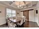 Elegant dining room features coffered ceiling, sliding barn door, and seating for six at 4191 Secret Shoals Way, Buford, GA 30518