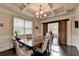 Elegant dining room features coffered ceiling, sliding barn door, and seating for six at 4191 Secret Shoals Way, Buford, GA 30518