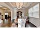 Elegant dining room showcasing a coffered ceiling, hardwood floors, and natural light at 4191 Secret Shoals Way, Buford, GA 30518