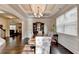 Elegant dining room features coffered ceiling, seating for six, window, and built-in hutch at 4191 Secret Shoals Way, Buford, GA 30518