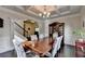 Dining area with hardwood flooring, wainscoting, chandelier, and built-in china cabinet at 4191 Secret Shoals Way, Buford, GA 30518