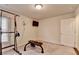 Carpeted gym featuring weight training equipment, television, fan, and natural light at 4191 Secret Shoals Way, Buford, GA 30518