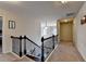 Open hallway with carpet, traditional railings, and pendant lighting leading to bedrooms at 4191 Secret Shoals Way, Buford, GA 30518