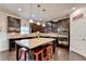 Gourmet kitchen featuring granite countertops, stainless steel appliances, and dark wood cabinets and floor at 4191 Secret Shoals Way, Buford, GA 30518