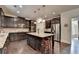 Modern kitchen featuring an island with bar stools, dark cabinetry, and stainless steel appliances at 4191 Secret Shoals Way, Buford, GA 30518