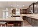 Well-lit kitchen featuring a large island, granite countertops, and stainless steel appliances at 4191 Secret Shoals Way, Buford, GA 30518