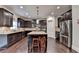 Spacious kitchen with a center island, stainless steel appliances, and dark wood cabinetry at 4191 Secret Shoals Way, Buford, GA 30518