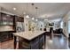 Open kitchen with a large island and breakfast bar, flowing into the living area at 4191 Secret Shoals Way, Buford, GA 30518