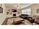 Inviting living room featuring a fireplace with built-in shelves and comfortable leather seating at 4191 Secret Shoals Way, Buford, GA 30518