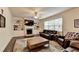 Bright living room features built-in shelving, fireplace, ceiling fan, and hardwood floors at 4191 Secret Shoals Way, Buford, GA 30518