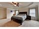 Main bedroom with tray ceiling and carpet, decorated with artwork at 4191 Secret Shoals Way, Buford, GA 30518