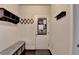 Functional mud room equipped with coat hooks, storage shelves and bench at 4191 Secret Shoals Way, Buford, GA 30518