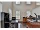 Bright office features large windows, high ceiling, hardwood floors, and ample workspace at 4191 Secret Shoals Way, Buford, GA 30518