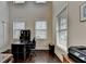 Well lit office space with dark wood flooring, two windows, and dark wood office furniture at 4191 Secret Shoals Way, Buford, GA 30518