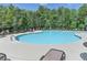 Community pool with ample lounge chairs, surrounded by lush trees and a relaxing atmosphere at 4191 Secret Shoals Way, Buford, GA 30518