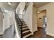 Staircase features dark wood stairs, carpeted landing, metal spindles, and neutral walls at 4191 Secret Shoals Way, Buford, GA 30518