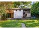 View of the back of the house with a backyard and a wooden deck, with staircase access to the first and second stories at 511 Oakview Rd, Decatur, GA 30030