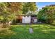 Backyard with a wood deck, staircase access to the first and second stories and lush green lawn at 511 Oakview Rd, Decatur, GA 30030
