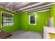 Basement area with exposed ceiling, vibrant green walls, and utility connections at 511 Oakview Rd, Decatur, GA 30030