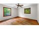 A bedroom with hardwood floors, two windows, and natural light illuminating the space at 511 Oakview Rd, Decatur, GA 30030