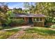 Charming brick home featuring mature trees, a well-kept lawn, and a cozy, inviting front porch at 511 Oakview Rd, Decatur, GA 30030