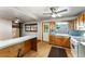 Open kitchen featuring wood cabinetry, a breakfast bar, a gas range, a window over the sink, and tile backsplash at 511 Oakview Rd, Decatur, GA 30030