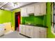 Small kitchenette area in the basement with cabinets, sink, and colorful walls at 511 Oakview Rd, Decatur, GA 30030