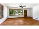 Well-lit living room boasts gleaming hardwood floors and a large window for ample natural light and a ceiling fan at 511 Oakview Rd, Decatur, GA 30030