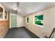 Sunroom with brick accent wall, a green door, and windows that overlook the backyard at 511 Oakview Rd, Decatur, GA 30030