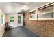 Enclosed sunroom features brick wall, lots of natural light, and access to the backyard at 511 Oakview Rd, Decatur, GA 30030