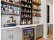Home bar features custom shelves, countertops, and beverage cooler at 6815 Halcyon Way, Alpharetta, GA 30005