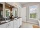 This bathroom features a double sink vanity with lots of natural light from the windows at 6815 Halcyon Way, Alpharetta, GA 30005