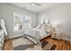 This bedroom features a bed, wood floors, neutral paint, and a nightstand with lamp at 6815 Halcyon Way, Alpharetta, GA 30005