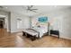 This spacious bedroom features hardwood floors, neutral paint, fan, and a bench at the end of the bed at 6815 Halcyon Way, Alpharetta, GA 30005