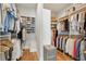 This walk-in closet offers plenty of storage with racks and shelves to organize clothes and accessories at 6815 Halcyon Way, Alpharetta, GA 30005