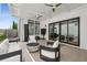 Inviting covered patio featuring a fire pit, comfortable seating, and sliding glass doors for seamless indoor-outdoor living at 6815 Halcyon Way, Alpharetta, GA 30005