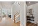 Bright entryway with open staircase, hardwood floors and modern powder room at 6815 Halcyon Way, Alpharetta, GA 30005