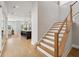 Bright entryway with open staircase, hardwood floors and open concept kitchen view at 6815 Halcyon Way, Alpharetta, GA 30005