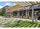 Exterior featuring checkerboard turf, modern outdoor seating, and overhead pergola creating an inviting space at 6815 Halcyon Way, Alpharetta, GA 30005