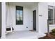 Inviting front porch with a charming porch swing and painted white flooring at 6815 Halcyon Way, Alpharetta, GA 30005