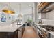 Open kitchen with a large island, modern appliances, white cabinets, and views of dining and living areas at 6815 Halcyon Way, Alpharetta, GA 30005