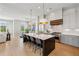 Spacious kitchen with a large island, seating, stainless steel appliances, and modern white and gray cabinets at 6815 Halcyon Way, Alpharetta, GA 30005