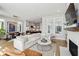 Open concept living room featuring hardwood floors, fireplace, and dining area at 6815 Halcyon Way, Alpharetta, GA 30005