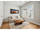 This bright living room features a sofa, a unique coffee table, and a neutral rug at 6815 Halcyon Way, Alpharetta, GA 30005