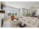 Open concept living room featuring hardwood floors, fireplace, and many windows at 6815 Halcyon Way, Alpharetta, GA 30005