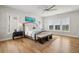 Serene main bedroom featuring hardwood floors, a ceiling fan, and large windows for plenty of natural light at 6815 Halcyon Way, Alpharetta, GA 30005