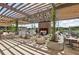Elegant outdoor lounge area with a fireplace feature and stylish seating arrangements at 6815 Halcyon Way, Alpharetta, GA 30005